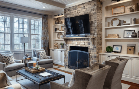 Family Room with Stacked Stone Fireplace, Custom Floating Mantle, Wall Mounted TV, Built-In Book Shelves, and Tongue & Groove Ceiling