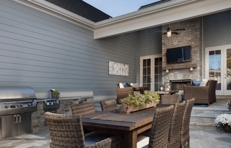 French doors open to the covered flagstone patio creating a seamless transition between the indoor and outdoor spaces. The patio and outdoor living area include a large wood burning fireplace w/floating mantel & mounted tv, outdoor kitchen w/stainless steel appliances, and a dining area great for outdoor entertaining.