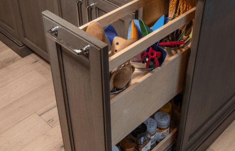 Custom kitchen includes custom cabinetry with pull-out spice drawers.