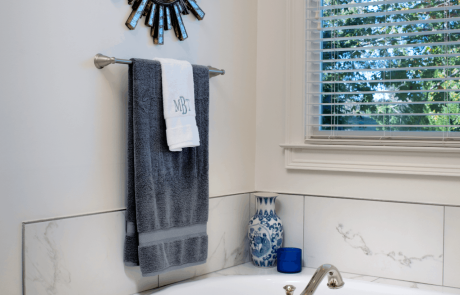 Master bathroom includes a large soaking tub with polished chrome fixtures and blue accents.