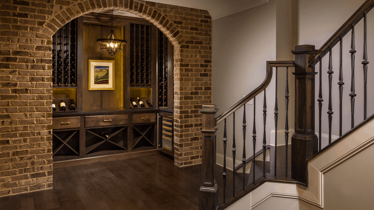 A totally remodeled staircase with new balusters, stair treads, and an expanded opening creates a dramatic entrance into this custom basement renovation.