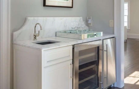 Master suite with custom coffee station and wet bar, white quartz countertops, wine storage, under counter refrigerator, ice maker and undermount bar sink with polished nickel faucet.