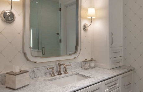 Second story transitional bathroom addition features custom white vanity with shaker cabinets, quartz countertops with undermount sink, polished nickel fixtures and wall sconces, white vanity mirror and Carrera Bianco marble floor.