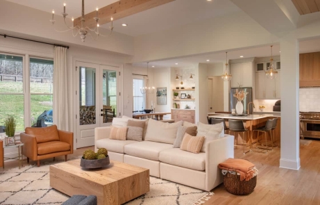 The bright and spacious open concept floor plan houses the kitchen, dining room and living areas and perfectly blends the warm wood tones, neutral colors, and natural textures throughout creating a cohesive and comfortable space for this family to relax and entertain.