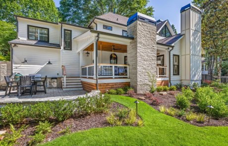 This custom backyard retreat in Roswell features a custom plunge pool, Techno Bloc 60 Paver Patio in Champlain Gray, outdoor kitchen with Black Pearl granite countertops, stainless steel appliances, a Green Egg, a covered porch with a Lueders limestone fireplace and custom pool landscape design.