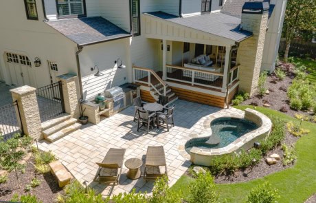 Custom plunge pool and backyard design with outdoor kitchen, paver patio, modern covered porch , outdoor fireplace and backyard landscape design plan.