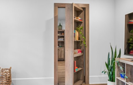 Hidden bookshelf door leading to a private man cave, adding a unique and functional design element to this custom home build.